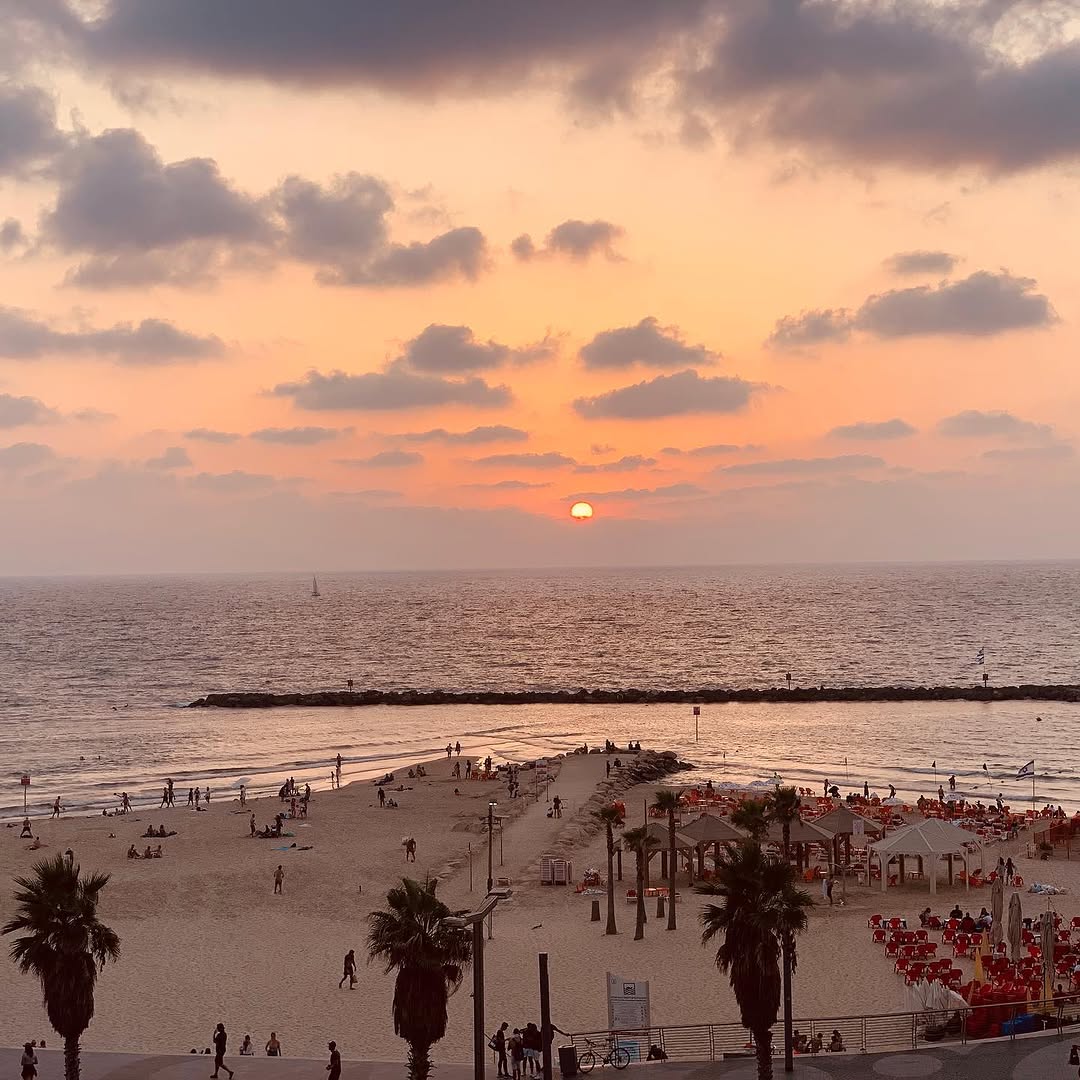 Sunset over a beach and ocean.