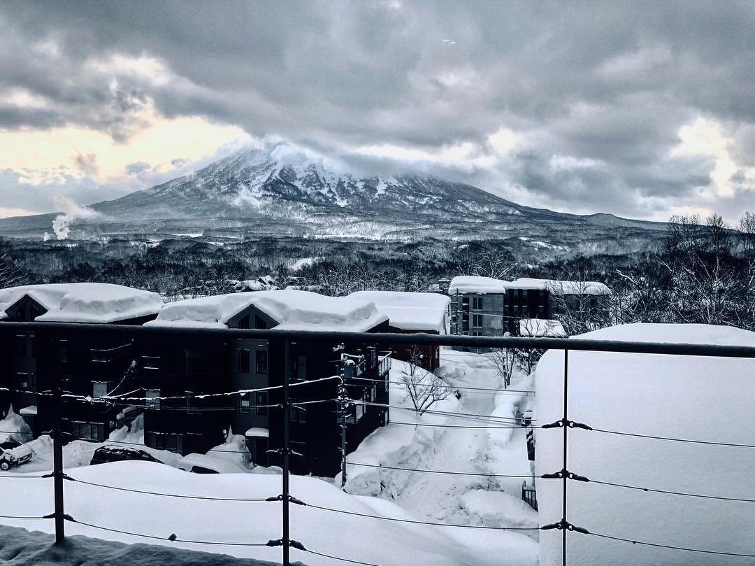 Snowy mountain under heavy clouds.